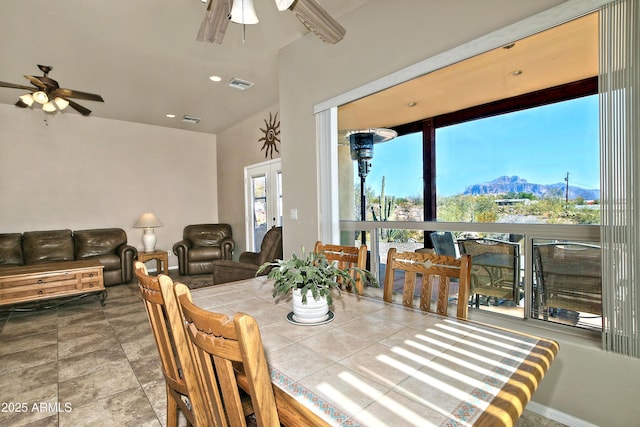 dining space with a mountain view, visible vents, and ceiling fan