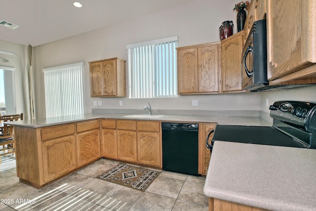 kitchen with visible vents, black appliances, a sink, a peninsula, and light countertops