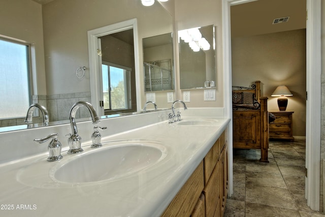 bathroom featuring a healthy amount of sunlight, visible vents, and a sink