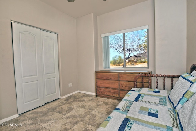 bedroom with a closet and baseboards