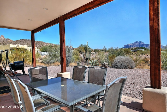 view of patio featuring outdoor dining space and a mountain view