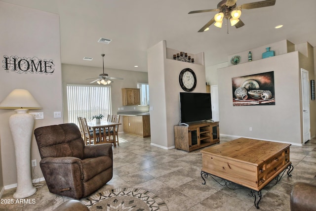 living room with visible vents, baseboards, and a ceiling fan