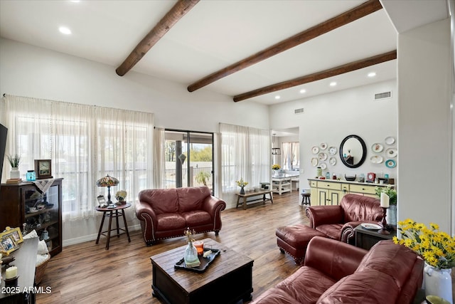 living area featuring beamed ceiling, wood finished floors, visible vents, and recessed lighting