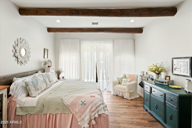 bedroom with beamed ceiling, recessed lighting, visible vents, and light wood-style floors