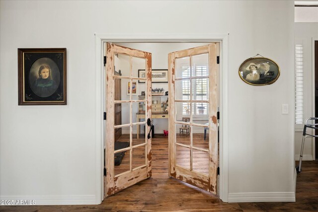 interior space featuring french doors, baseboards, and wood finished floors