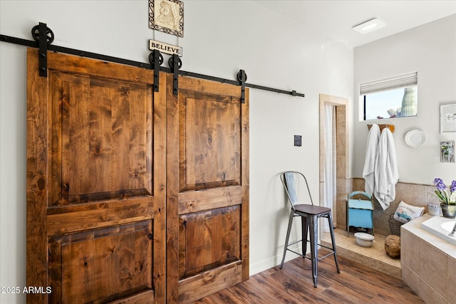 interior space featuring a barn door and dark wood-style flooring