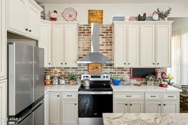 kitchen with appliances with stainless steel finishes and wall chimney exhaust hood