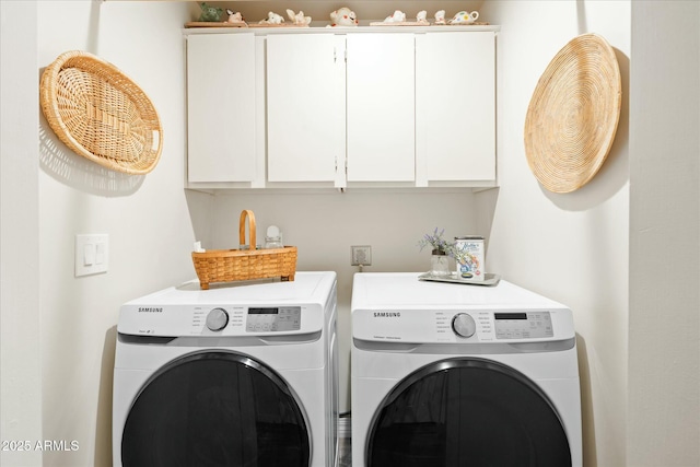 laundry room with cabinet space and washer and dryer