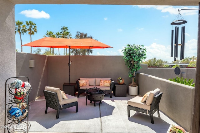 view of patio featuring fence and an outdoor living space with a fire pit