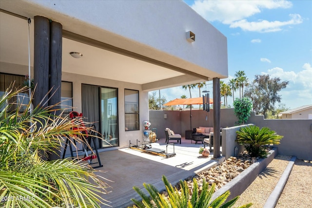 view of patio featuring an outdoor fire pit and a fenced backyard