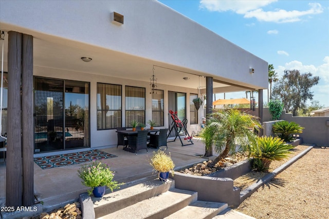 exterior space with a porch and stucco siding