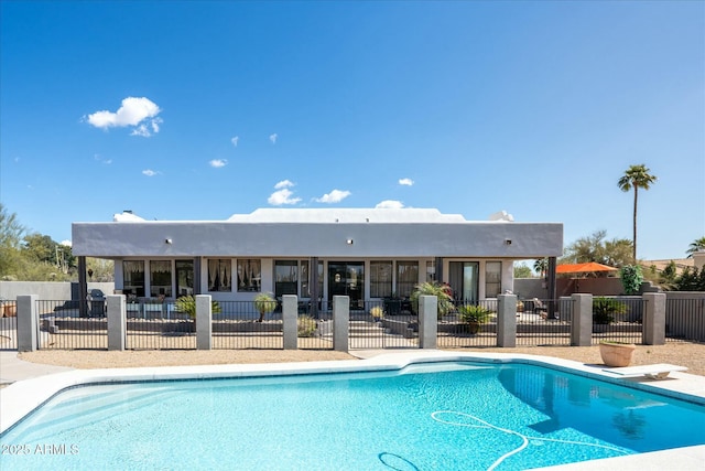 view of swimming pool with a patio area, fence, a diving board, and a fenced in pool