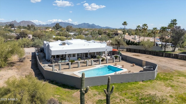 view of pool with a fenced in pool, a mountain view, fence, and a patio