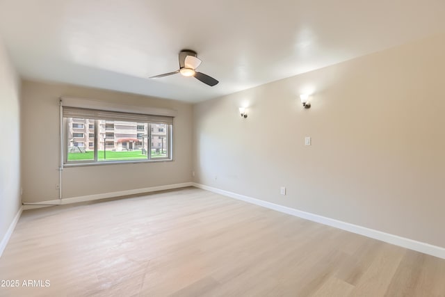 7970 E Camelback Rd Unit 110, Scottsdale, AZ 85251 - spare room featuring light wood-style floors, baseboards, and a ceiling fan