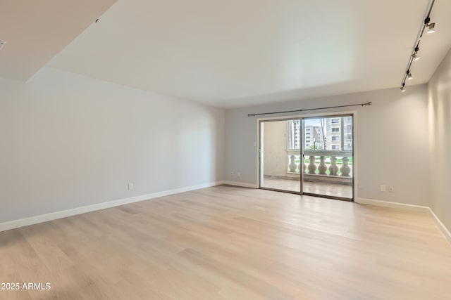 7970 E Camelback Rd Unit 110, Scottsdale, AZ 85251 - unfurnished room featuring light wood-style floors, track lighting, and baseboards