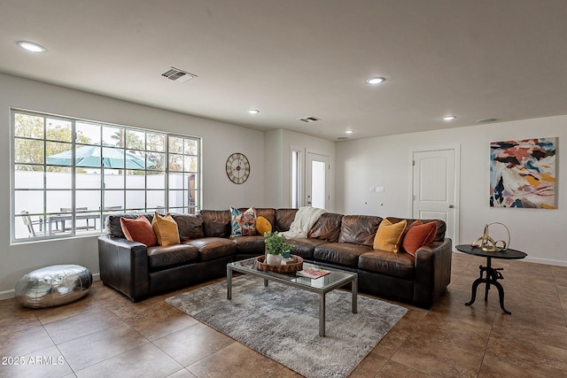 living room with a wealth of natural light and dark tile patterned floors