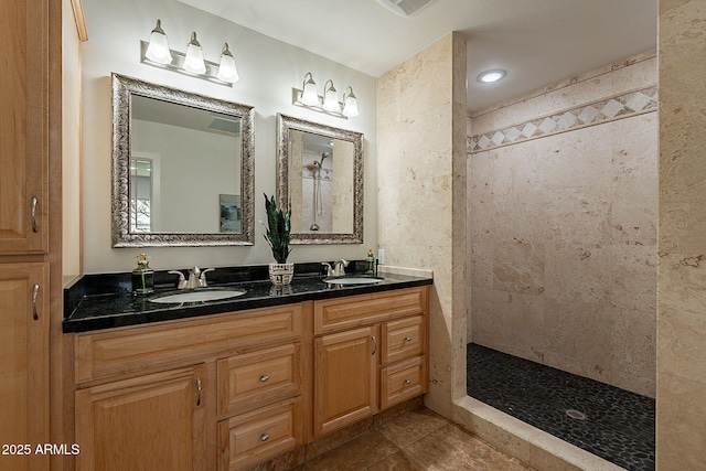 bathroom with vanity and tiled shower