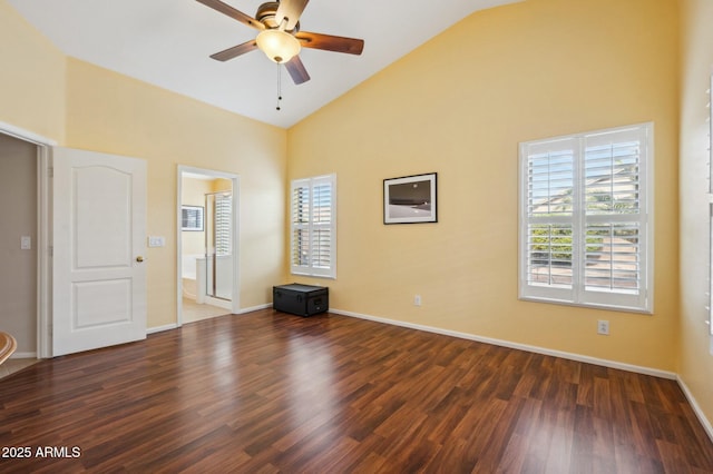 spare room with high vaulted ceiling, ceiling fan, and dark wood-type flooring