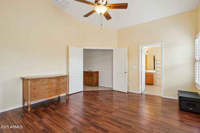 bedroom featuring connected bathroom, ceiling fan, and dark wood-type flooring