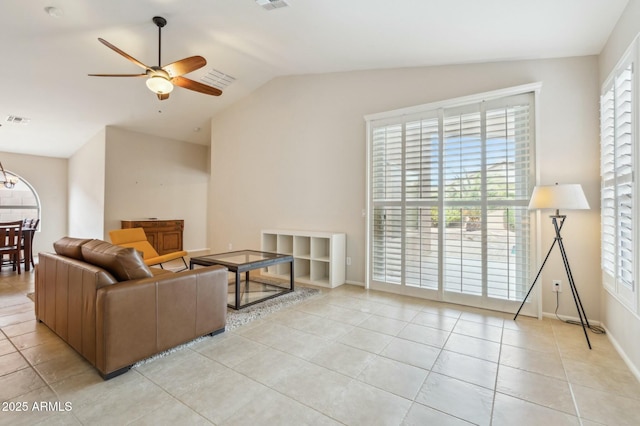 tiled living room featuring ceiling fan and lofted ceiling