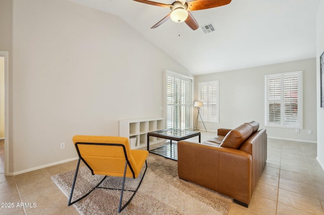 living room with ceiling fan, light tile patterned flooring, and vaulted ceiling