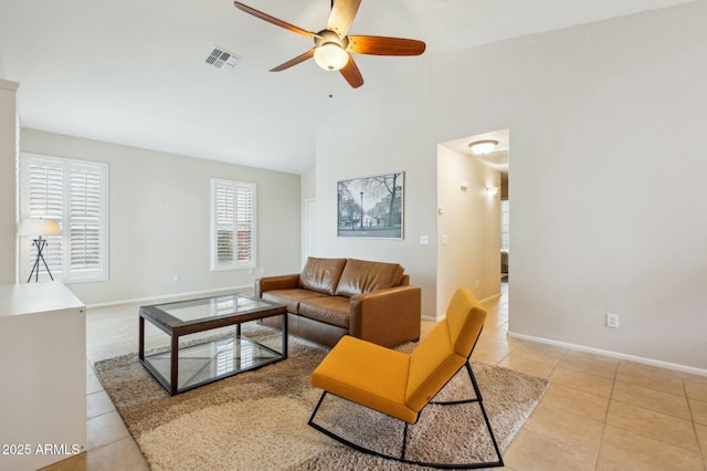 tiled living room with ceiling fan and a wealth of natural light