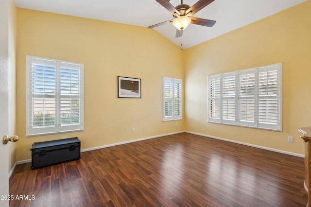 empty room featuring a wealth of natural light, dark hardwood / wood-style flooring, and ceiling fan