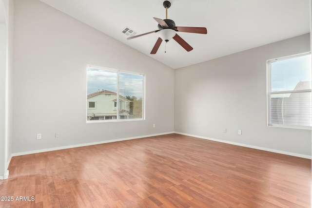 spare room featuring hardwood / wood-style flooring, vaulted ceiling, and ceiling fan