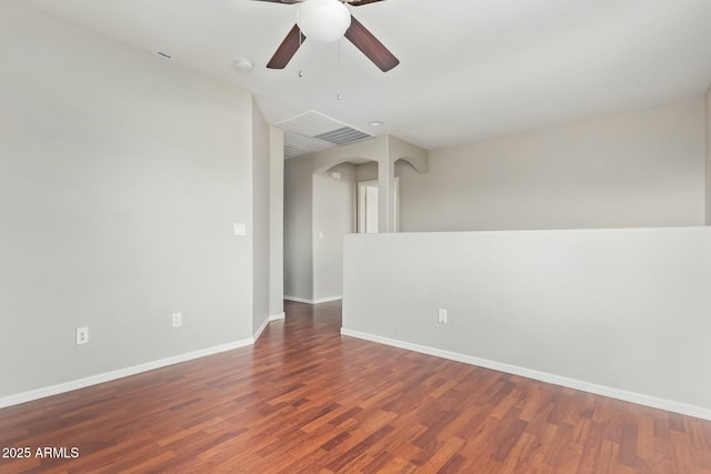 unfurnished room with dark hardwood / wood-style flooring and ceiling fan