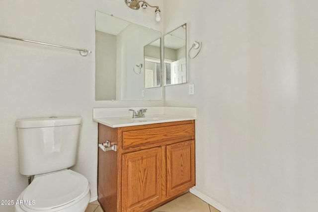 bathroom featuring vanity, tile patterned floors, and toilet