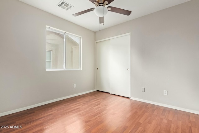 spare room featuring hardwood / wood-style flooring and ceiling fan