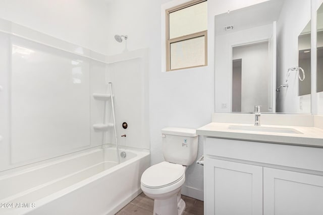 full bath featuring toilet, shower / washtub combination, wood finished floors, and vanity