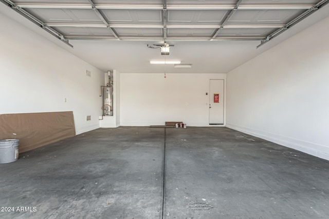 garage featuring a garage door opener and gas water heater