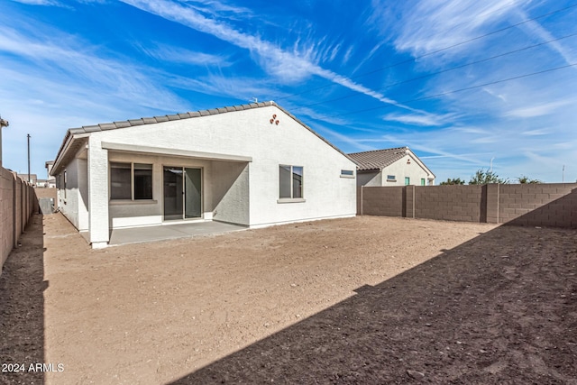 back of property featuring a patio area, a fenced backyard, a tile roof, and stucco siding