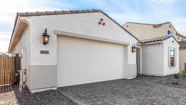 exterior space featuring fence and decorative driveway