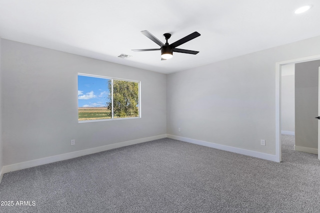 empty room featuring a ceiling fan, carpet flooring, visible vents, and baseboards