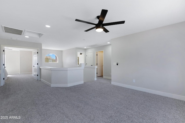 empty room featuring recessed lighting, visible vents, attic access, light carpet, and baseboards