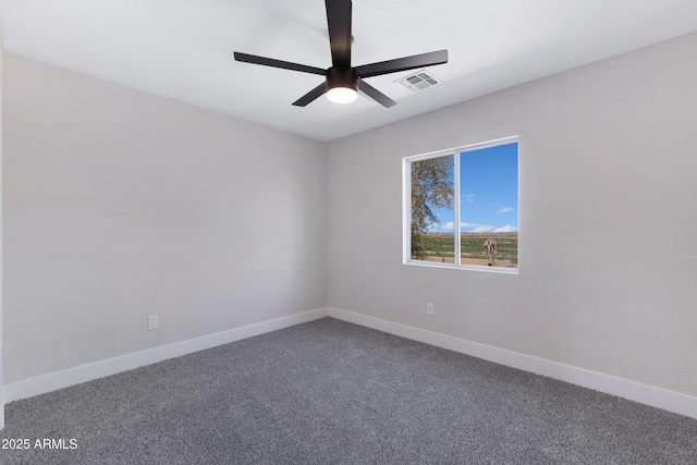 carpeted empty room with ceiling fan, visible vents, and baseboards