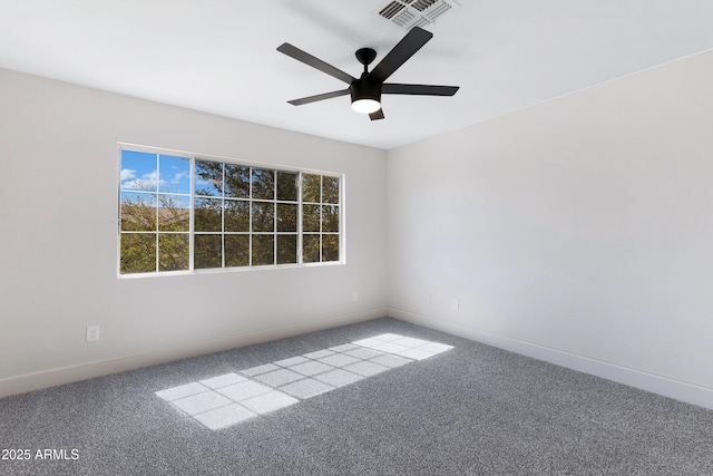 carpeted empty room with ceiling fan, visible vents, and baseboards