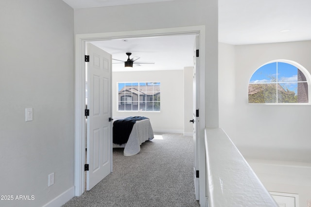 corridor featuring carpet and baseboards