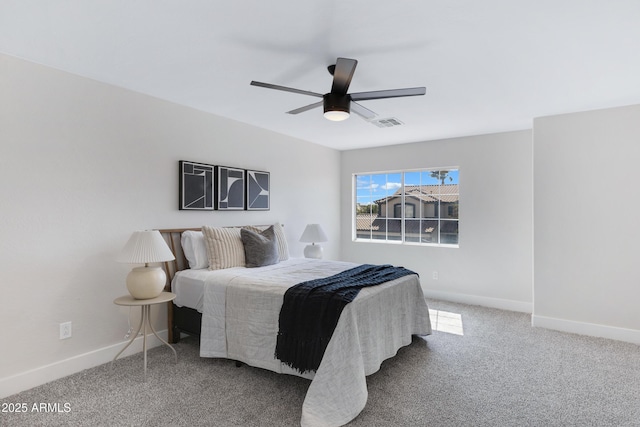 carpeted bedroom with visible vents, baseboards, and a ceiling fan