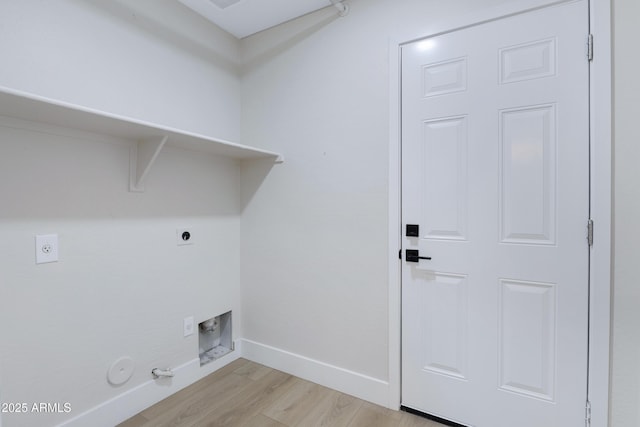 clothes washing area with light wood-style flooring, hookup for a gas dryer, hookup for an electric dryer, laundry area, and baseboards