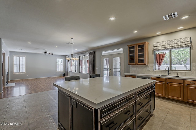 kitchen with visible vents, a sink, and light tile patterned floors