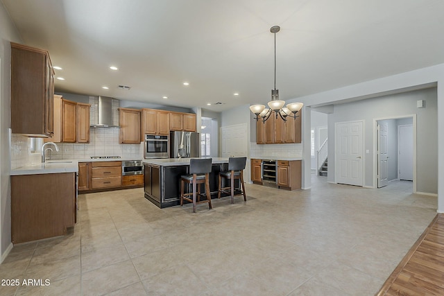 kitchen featuring wine cooler, a sink, a center island, stainless steel appliances, and wall chimney range hood