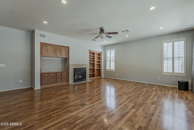 unfurnished living room with visible vents, recessed lighting, a ceiling fan, and dark wood finished floors
