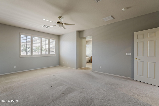 unfurnished room with carpet flooring, visible vents, baseboards, and ceiling fan