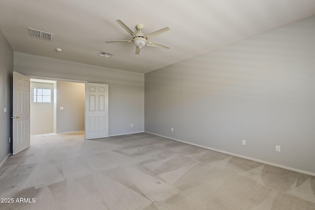 unfurnished bedroom with baseboards, light colored carpet, and visible vents
