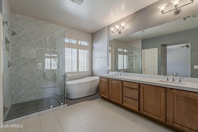 bathroom with double vanity, a sink, a freestanding bath, and a shower stall