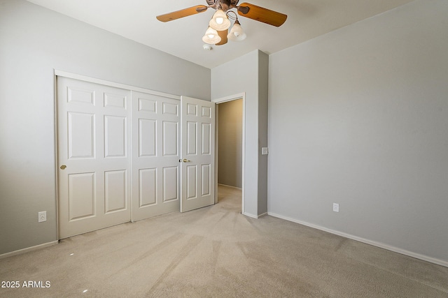 unfurnished bedroom featuring baseboards, a closet, ceiling fan, and carpet