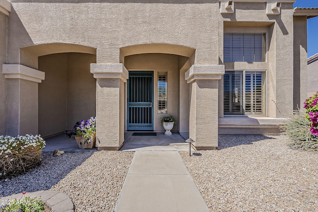 entrance to property with stucco siding